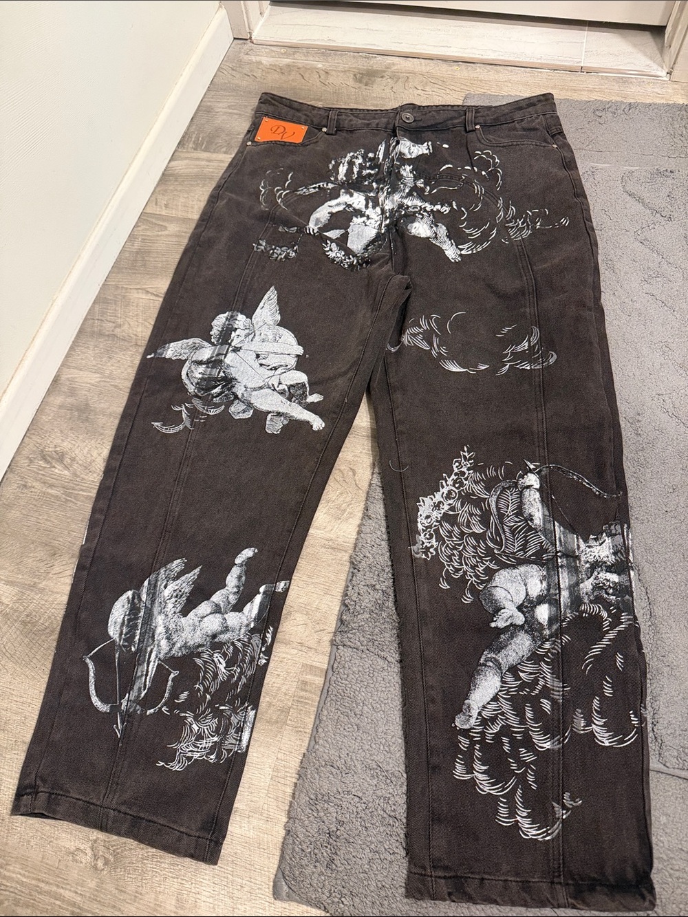 Relaxed Black Jeans with White Cherub Graphics